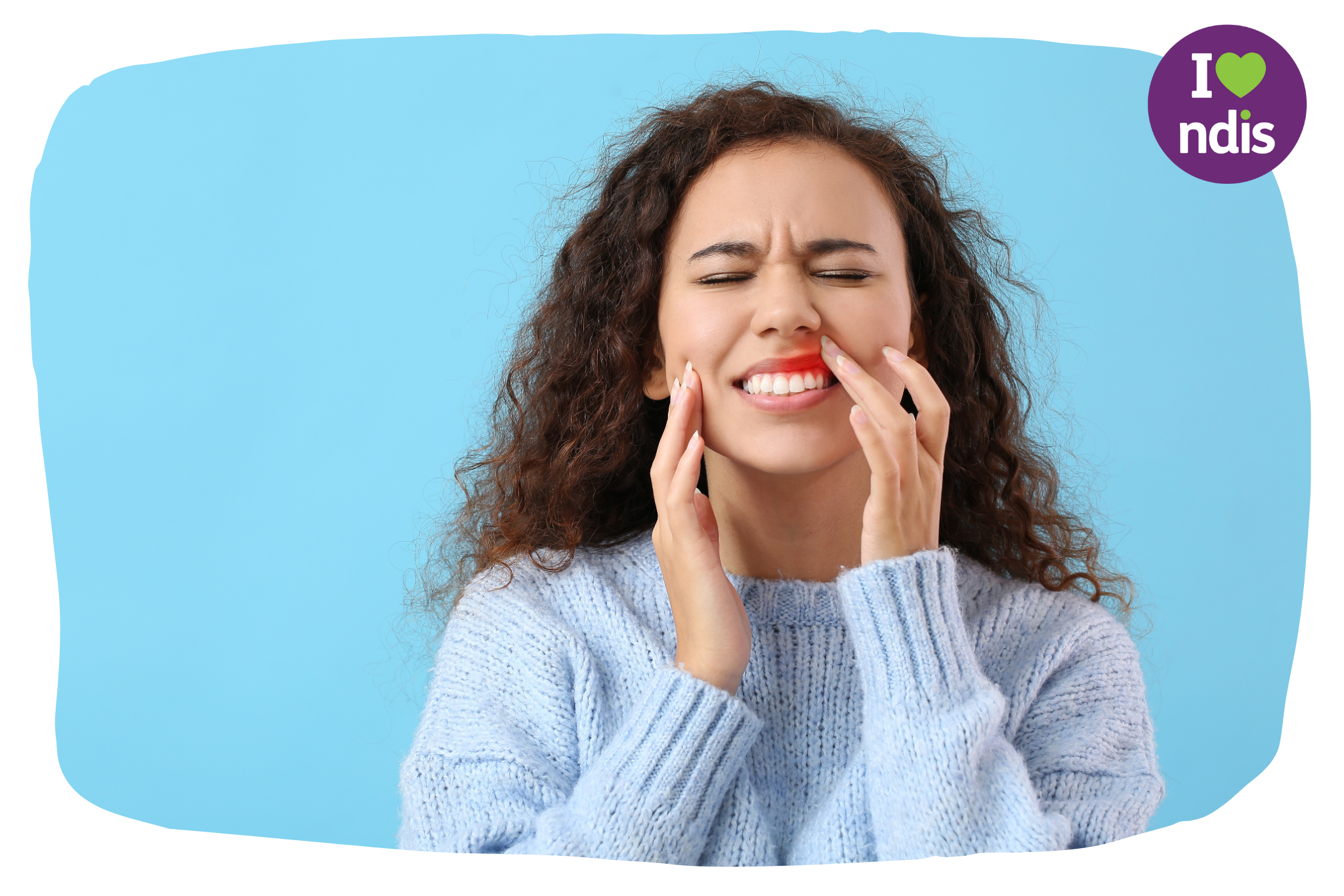A girl in her mid twenties pressing on her lip in pain. A red area on her gums suggests she has an oral pain.