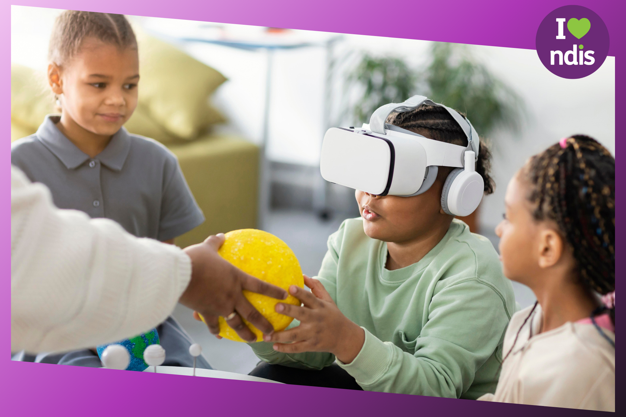 A child using assistive technology in a care centre. She has a virtual reality headset on and is holding a yellow ball in her hands/